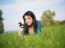 Young Woman Using Mobile Phone In Park