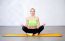 Young Fitness Woman Doing Yoga Exercises Sitting In Lotus Positi