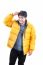 Portrait Of Young Asian Man Wearing Yellow Winter Jacket And Bla