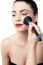 Pretty Woman Applying Makeup With Brush