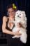 Young Widow Woman In Sexy Black Dress Hold In Hands White Dog