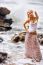 Beautiful Young Blonde Woman Posing Outdoor At The Rocky Sea Sho