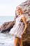 Beautiful Young Blonde Woman Posing Outdoor At The Rocky Sea Sho