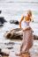 Beautiful Young Blonde Woman Posing Outdoor At The Rocky Sea Sho