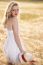 Lonely Beautiful Young Blonde Girl In White Dress With Straw Hat