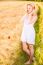 Lonely Beautiful Young Blonde Girl In White Dress With Straw Hat