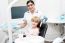 Little Girl Sitting In Dental Clinic