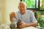 Asian Senior Man With Vintage Coffee Grinder