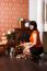 Young Beautiful Woman Sits Near The Fireplace