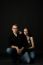 Handsome Young Couple Posing Sitting In Studio