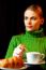 Young Woman Making Breakfast With A Cup Of Cappuccino And Croiss