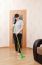 Woman Washes Wooden Floor With A Mop