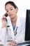 Asian Female Doctor Talking Over Phone