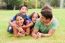 Playful Family Lying Outdoors And Smiling