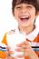 Smiling Young Boy Holding A Glass Of Milk