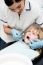 Cute Kid Examined By Dental Assitant