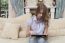 Woman Relaxing On A Sofa With Her Digital Table