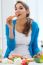 Pretty Young Woman Having Fun With A Carrot In The Kitchen