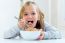 Beautiful Child Having Breakfast At Home