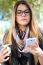 Portrait Of Beautiful Girl Drinking Coffee And Using Her Mobile