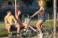 Group Of Friends With Roller Skates And Bike Riding In The Park