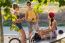 Group Of Friends With Roller Skates And Bike Riding In The Park