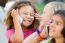 Group Of Childrens Using Mobile Phones In The Park