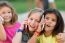 Group Of Childrens Using Mobile Phones In The Park