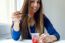 Young Beautiful Woman Eating Yogurt At Home