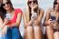 Three Girls Chatting With Their Smartphones At The Campus