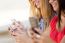 Three Girls Chatting With Their Smartphones At The Campus