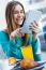 Pretty Woman Using Tablet While Having Breakfast In Coffee Shop