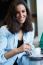 Pretty Young Woman Sitting In A Cafe With A Cup Of Coffee