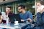 Outdoor Portrait Of Young Entrepreneurs Working At Coffee Bar