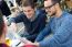 Outdoor Portrait Of Young Entrepreneurs Working At Coffee Bar