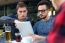 Outdoor Portrait Of Young Entrepreneurs Working At Coffee Bar