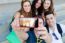 Group Of Friends Taking Photos With A Smartphone In The Street