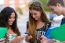 A Group Of Students Having Fun With Smartphones After Class