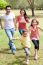 Family Playing In The Green Field