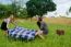 Two Girls  Spreading A Blanket For Picnic