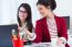 Two Young Businesswomen Working With Laptop In Her Office