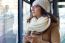 Young Beautiful Woman Using Her Mobile Phone On A  Bus