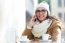 Young Beautiful Woman Using Her Mobile Phone In A Cafe