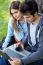 Portrait Of Young Couple At The Park Using A Laptop