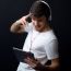 Young Beautiful Man Listening To Music. Isolated On Black