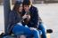 Young Couple Of Tourist In Town Using Mobile Phone