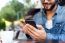 Modern Young Man With Mobile Phone In The Street