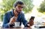 Modern Young Man With Mobile Phone In The Street