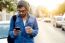 Modern Young Man With Mobile Phone In The Street