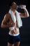 Beautiful And Muscular Man Drinking Water In Dark Background